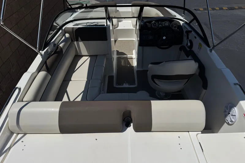 Slide: The Image of 2019 Bayliner 195 Deck Boat interior with seating and steering console. - 9