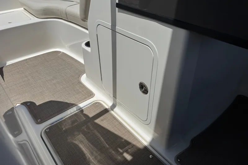Slide: The Image of Interior view of a 2019 Bayliner 195 Deck Boat, featuring seating and storage compartment. - 30