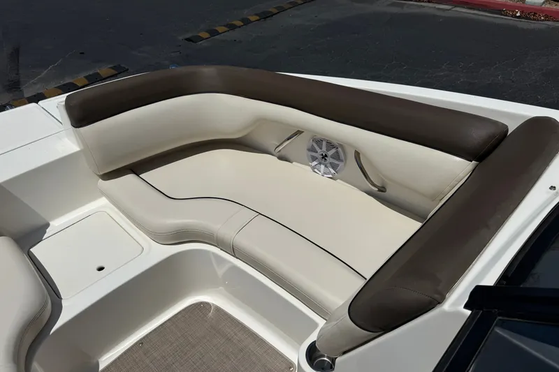 Slide: The Image of 2019 Bayliner 195 Deck Boat interior with cushioned seating and speaker system. - 15