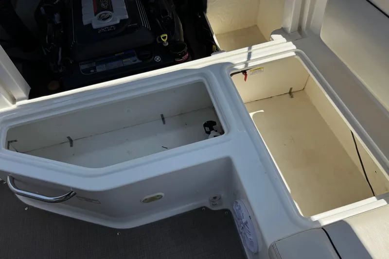 Slide: The Image of Open storage compartments on a 2019 Bayliner 195 Deck Boat. - 21