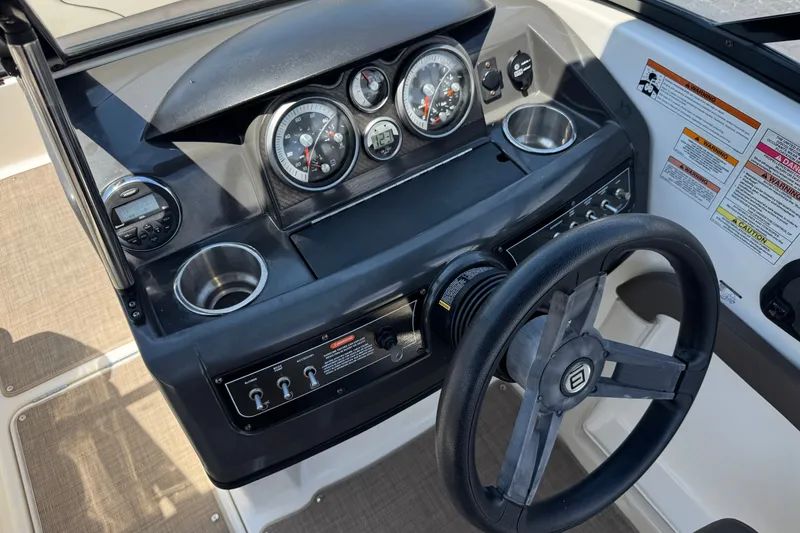 Slide: The Image of Dashboard of a 2019 Bayliner 195 Deck Boat with steering wheel and gauges. - 28