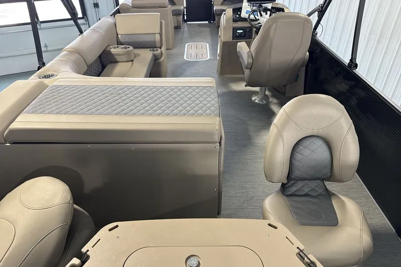 Slide: The Image of Interior of a 2022 Bennington 25 LSAPG pontoon boat with luxurious seating and modern design. - 9