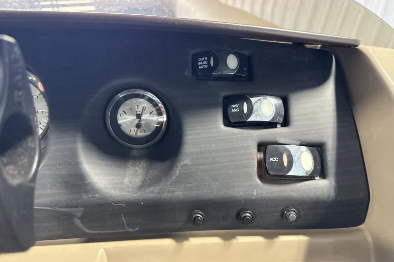 Slide: The Image of Dashboard controls of a 2022 Bennington 25 LSAPG boat, featuring fuel gauge and switches. - 17