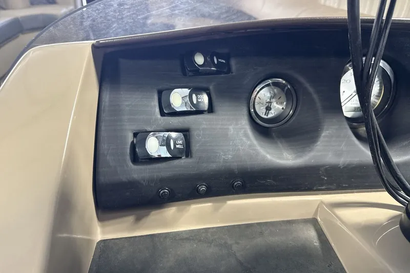 Slide: The Image of Dashboard controls of a 2022 Bennington 25 LSAPG boat, featuring switches and gauges. - 18