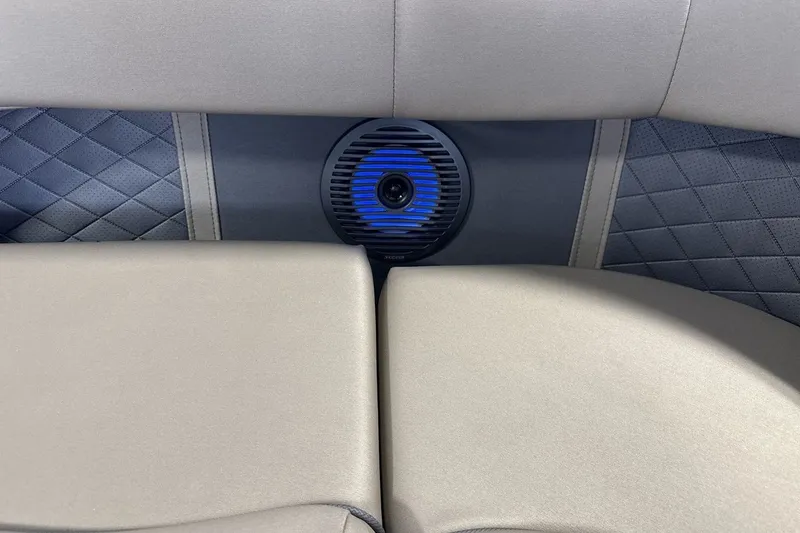Slide: The Image of 2022 Bennington 25 LSAPG boat interior with blue-lit speaker and quilted upholstery. - 19