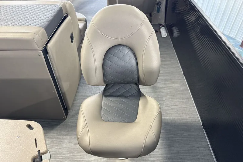 Slide: The Image of Captain's chair in 2022 Bennington 25 LSAPG boat, featuring beige and black upholstery. - 24