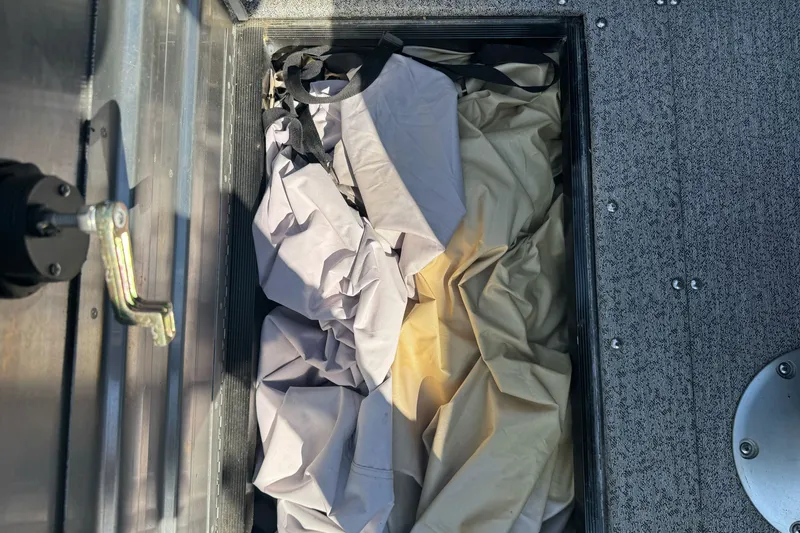 Slide: The Image of Storage compartment in 2021 Tracker Pro Guide V-175 Combo boat with fabric inside. - 17