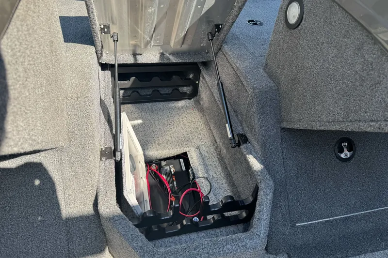 Slide: The Image of 2021 Tracker Pro Guide V-175 Combo boat storage compartment with battery and wiring. - 21