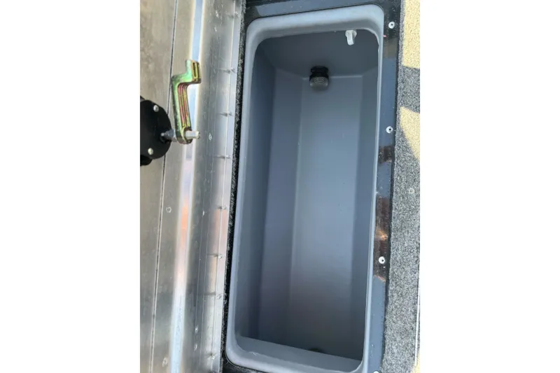 Slide: The Image of 2021 Tracker Pro Guide V-175 Combo storage compartment with metal latch and gray interior. - 26