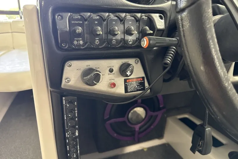 Slide: The Image of 2016 Moomba Mojo dashboard controls with switches and ignition key. - 15