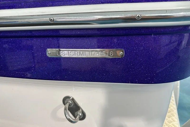 Slide: The Image of 2016 Moomba Mojo boat with purple glitter finish and visible hull identification number. - 25
