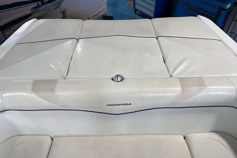 Slide: The Image of 2016 Moomba Mojo boat interior with white cushioned seating and sleek design. - 19