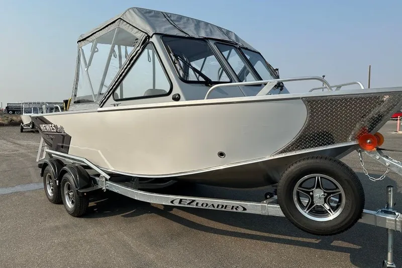 The Image of 2026 Hewescraft 180 ProV ET boat on trailer, featuring a sleek design and canopy. - 2