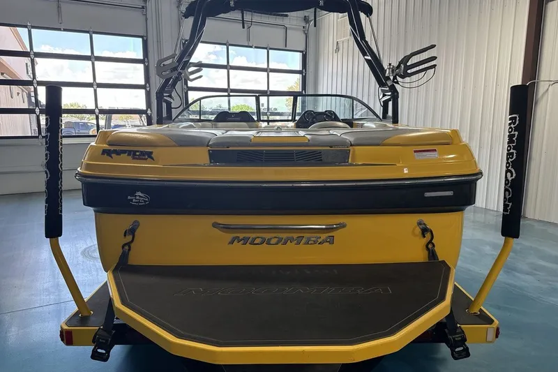 Slide: The Image of 2016 Moomba Mondo boat in a garage, showcasing its yellow exterior and wakeboard tower. - 4