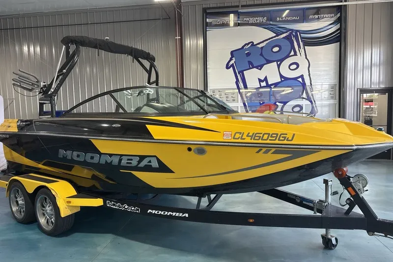 Slide: The Image of 2016 Moomba Mondo boat in yellow and black on a trailer inside a showroom. - 7
