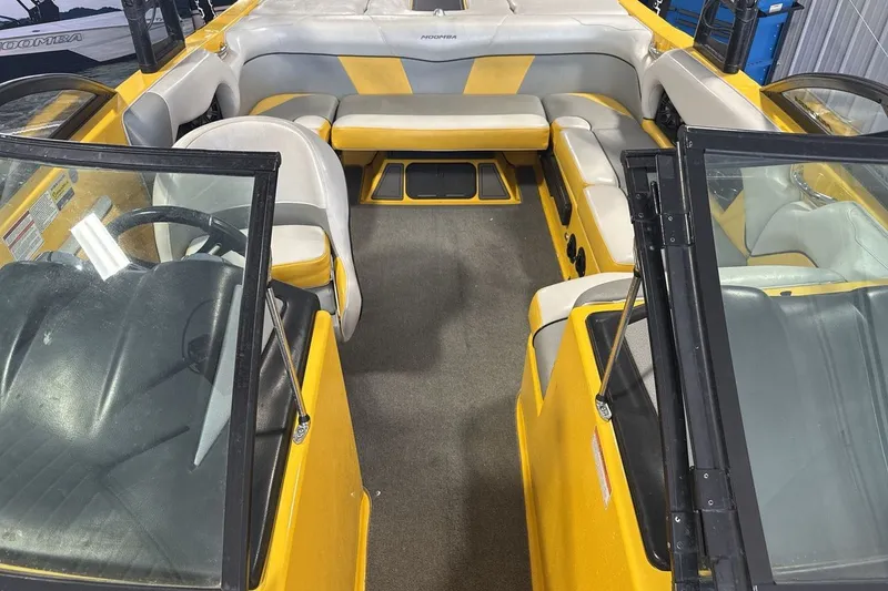 Slide: The Image of 2016 Moomba Mondo boat interior with yellow and gray seating, open cockpit view. - 12