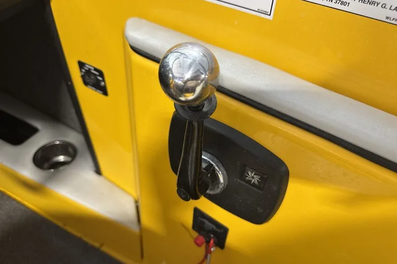 Slide: The Image of 2016 Moomba Mondo boat throttle lever on a yellow dashboard. - 16