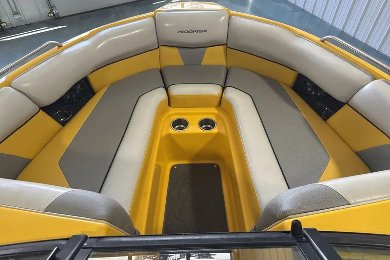 Slide: The Image of 2016 Moomba Mondo boat interior with yellow and gray seating, cup holders, and spacious layout. - 11