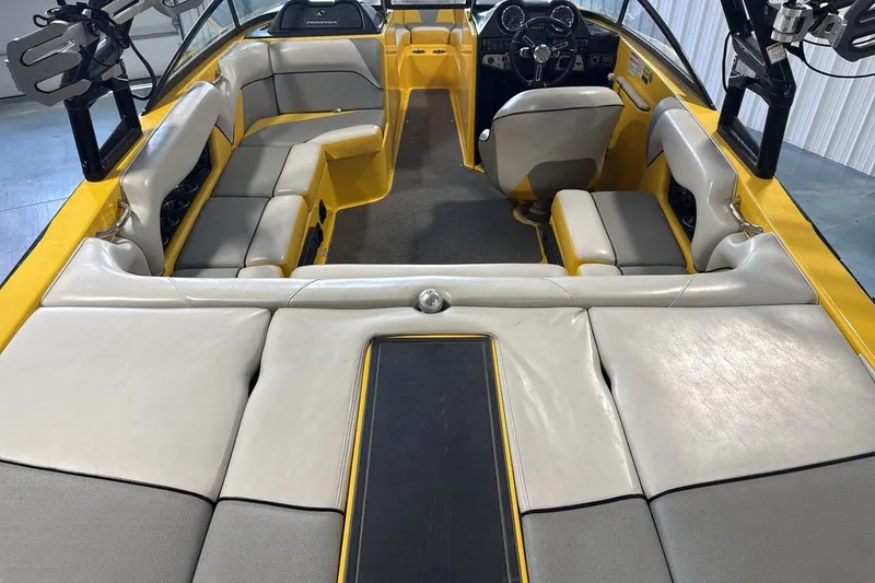 Slide: The Image of 2016 Moomba Mondo boat interior with yellow and gray seating, featuring a sleek, modern design. - 9