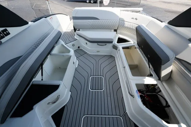 Slide: The Image of 2027 Sea Ray SLX 280 boat interior with open storage compartments and sleek seating. - 18