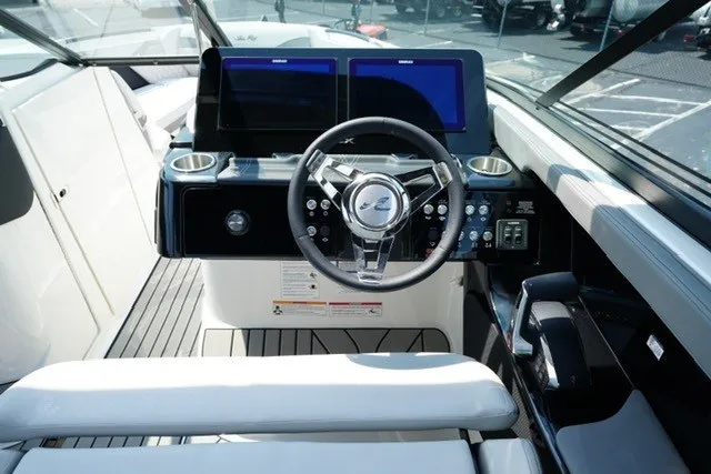 Slide: The Image of 2027 Sea Ray SLX 280 boat cockpit with modern steering and dual screens. - 14