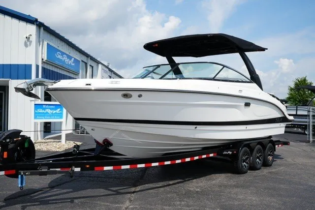 Slide: The Image of 2027 Sea Ray SLX 280 boat on trailer, parked outside dealership. - 2