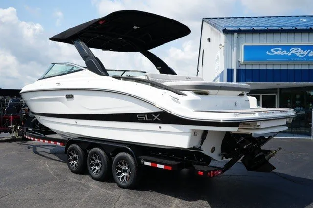 Slide: The Image of 2027 Sea Ray SLX 280 boat on trailer, parked outside dealership. - 7