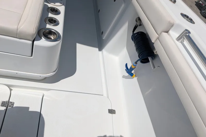 Slide: The Image of Interior view of a 2022 Yellowfin 36 Offshore boat, featuring seating and cup holders. - 32