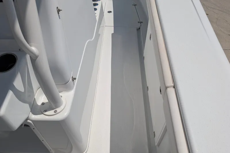 Slide: The Image of 2022 Yellowfin 36 Offshore boat interior, showcasing sleek white deck and storage compartments. - 27