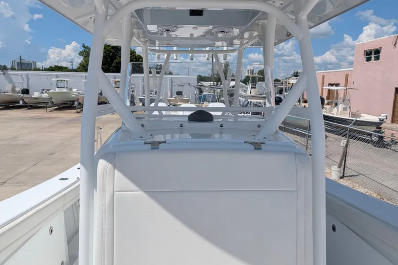 Slide: The Image of 2022 Yellowfin 36 Offshore boat interior, showcasing helm station and seating under clear blue sky. - 29