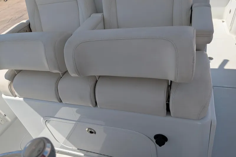 Slide: The Image of 2022 Yellowfin 36 Offshore boat seating with white cushioned armrests. - 17