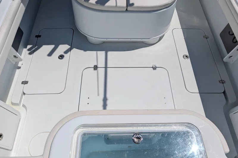 Slide: The Image of 2022 Yellowfin 36 Offshore boat deck with storage compartments and seating area. - 9