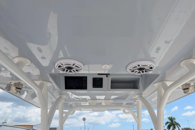 Slide: The Image of 2022 Yellowfin 36 Offshore boat console with speakers and electronic displays under a clear sky. - 22