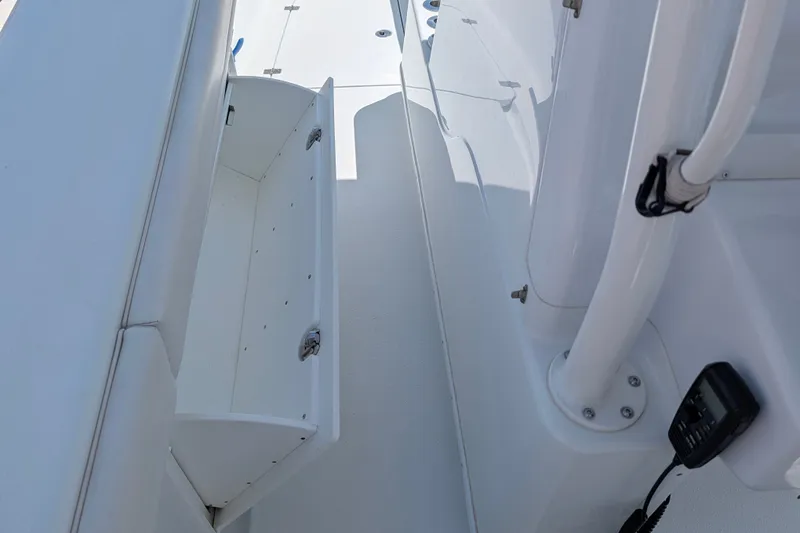 Slide: The Image of Interior view of a 2022 Yellowfin 36 Offshore boat, featuring storage compartment and marine equipment. - 24