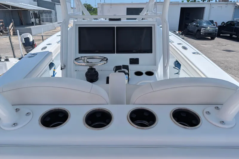 Slide: The Image of 2022 Yellowfin 36 Offshore boat cockpit with dual screens and cup holders. - 14