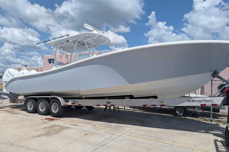The Image of 2022 Yellowfin 36 Offshore boat on trailer under a cloudy sky. - 0