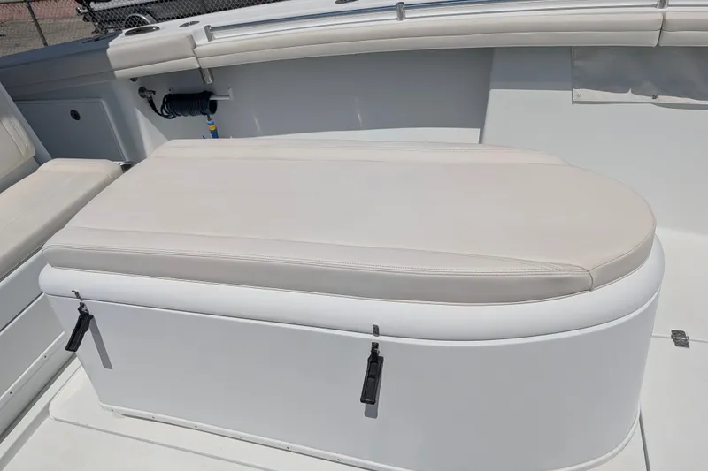 Slide: The Image of 2022 Yellowfin 36 Offshore boat with cushioned seating and storage compartment. - 34