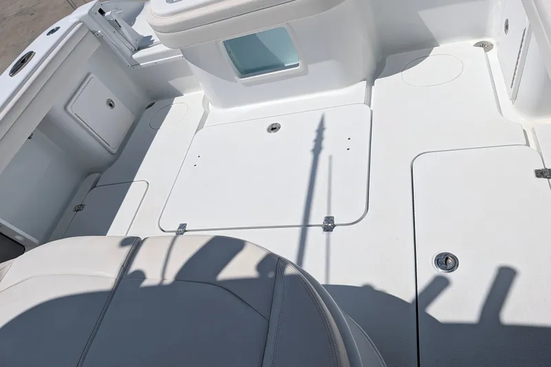 Slide: The Image of 2022 Yellowfin 36 Offshore boat deck with storage compartments and seating. - 19