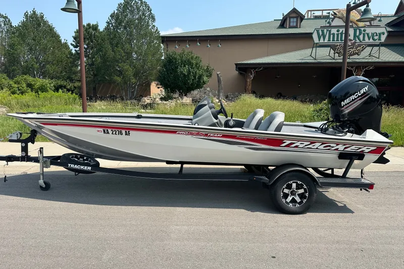 The Image of 2017 Tracker Pro Team 195 Tournament Edition boat on trailer, parked near White River Fly Shop. - 0