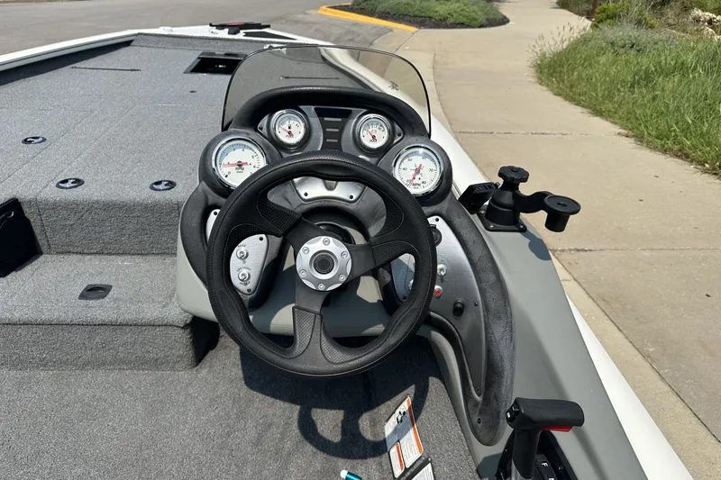 Slide: The Image of 2017 Tracker Pro Team 195 Tournament Edition boat dashboard with steering wheel and gauges. - 14