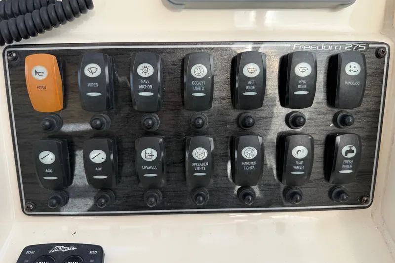 Slide: The Image of Control panel of a 2020 Grady-White Freedom 275 boat with labeled switches. - 17