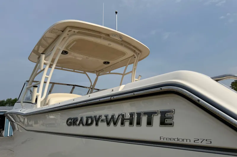 Slide: The Image of 2020 Grady-White Freedom 275 boat, showcasing sleek design and branding. - 2