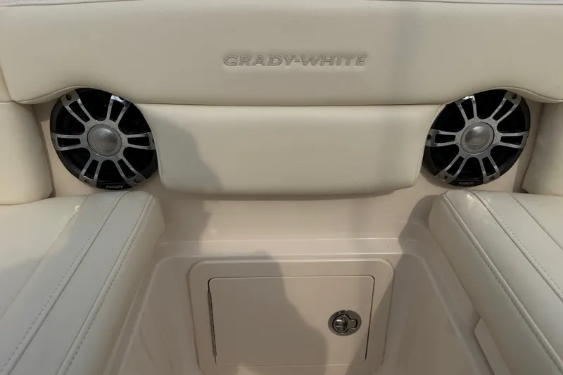 Slide: The Image of Grady-White Freedom 275 boat interior with speakers, 2020 model, featuring plush seating. - 13