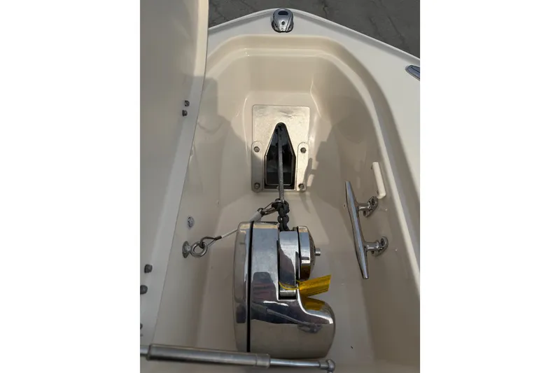Slide: The Image of Anchor compartment of 2020 Grady-White Freedom 275 boat, featuring a polished anchor winch. - 12