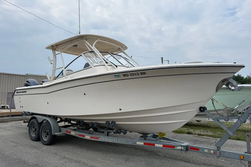 The Image of 2020 Grady-White Freedom 275 boat on trailer, parked outdoors. - 0