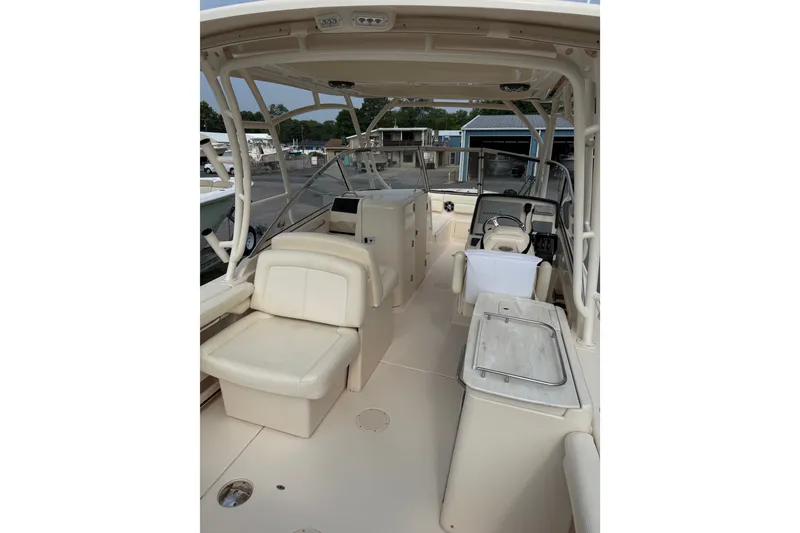Slide: The Image of 2020 Grady-White Freedom 275 boat interior with seating and helm station. - 20