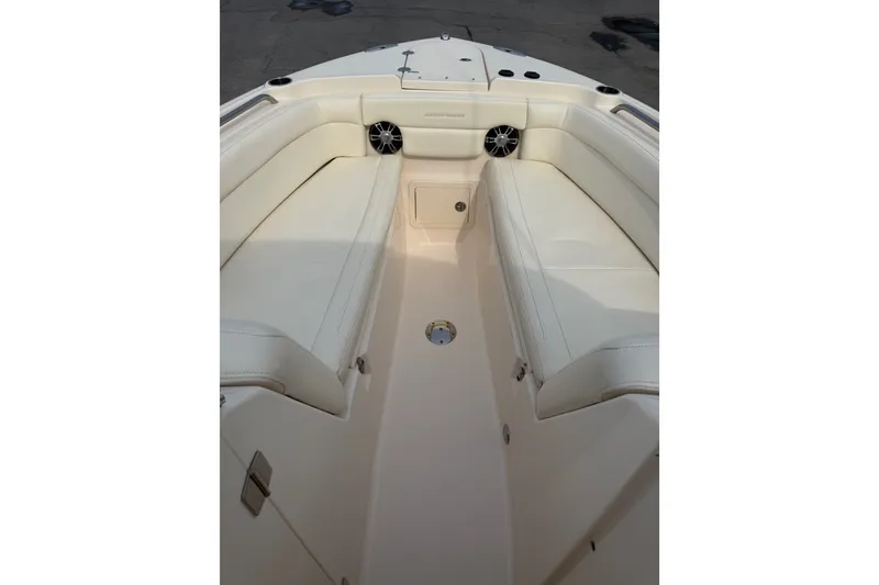 Slide: The Image of 2020 Grady-White Freedom 275 boat interior with white seating and speakers. - 14