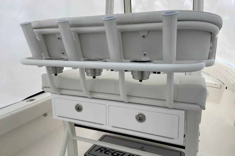 Slide: The Image of 2027 Regulator 24XO boat interior with rod holders and storage drawers. - 2