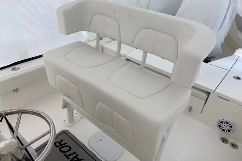 Slide: The Image of 2027 Regulator 24XO boat interior with white cushioned seating and steering wheel. - 4