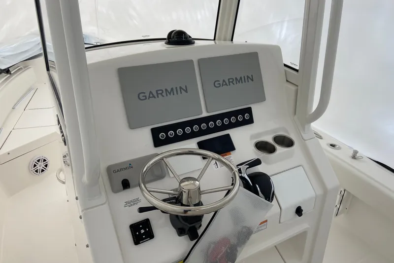 Slide: The Image of Helm of 2027 Regulator 24XO boat with dual Garmin displays and steering wheel. - 3